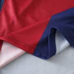 Close-up of the Barcelona x Coldplay Special Release Fan Version jersey fabric showing red and navy blue stitching details.