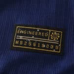 Close-up of Barcelona x Coldplay special release, player version jersey label with "Engineered" and serial number MB2561800.B.