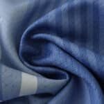 Close-up of the Tottenham x Travis Scott special release fan version fabric, showcasing high-quality blue material with subtle patterns.