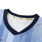 Close-up of Tottenham x Travis Scott special release fan version jersey collar, highlighting the "COYS" and Nike branding.