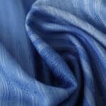 Close-up of navy blue fabric with intricate, textured patterns from the Tottenham x Travis Scott (Special Release) Player Version collection.