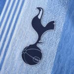 Close-up of the Tottenham Hotspur emblem embroidered on a blue fabric for the Tottenham x Travis Scott (Special Release) Player Version.