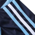 Close-up of the Argentina Retro Away 2006 Fan Version jersey featuring light blue and white stripes on a dark fabric.
