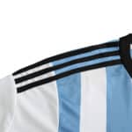 Close-up of Argentina Retro Home 2014 Fan Version jersey, showcasing white and blue stripes with black collar and three shoulder stripes.