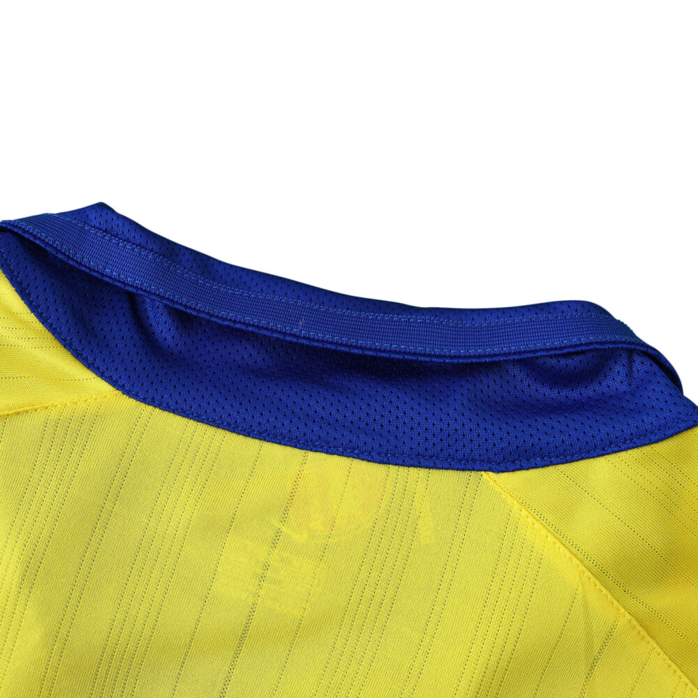 Close-up of the collar on an Arsenal Retro Away 2003/04 fan version jersey, showcasing its yellow and blue design.