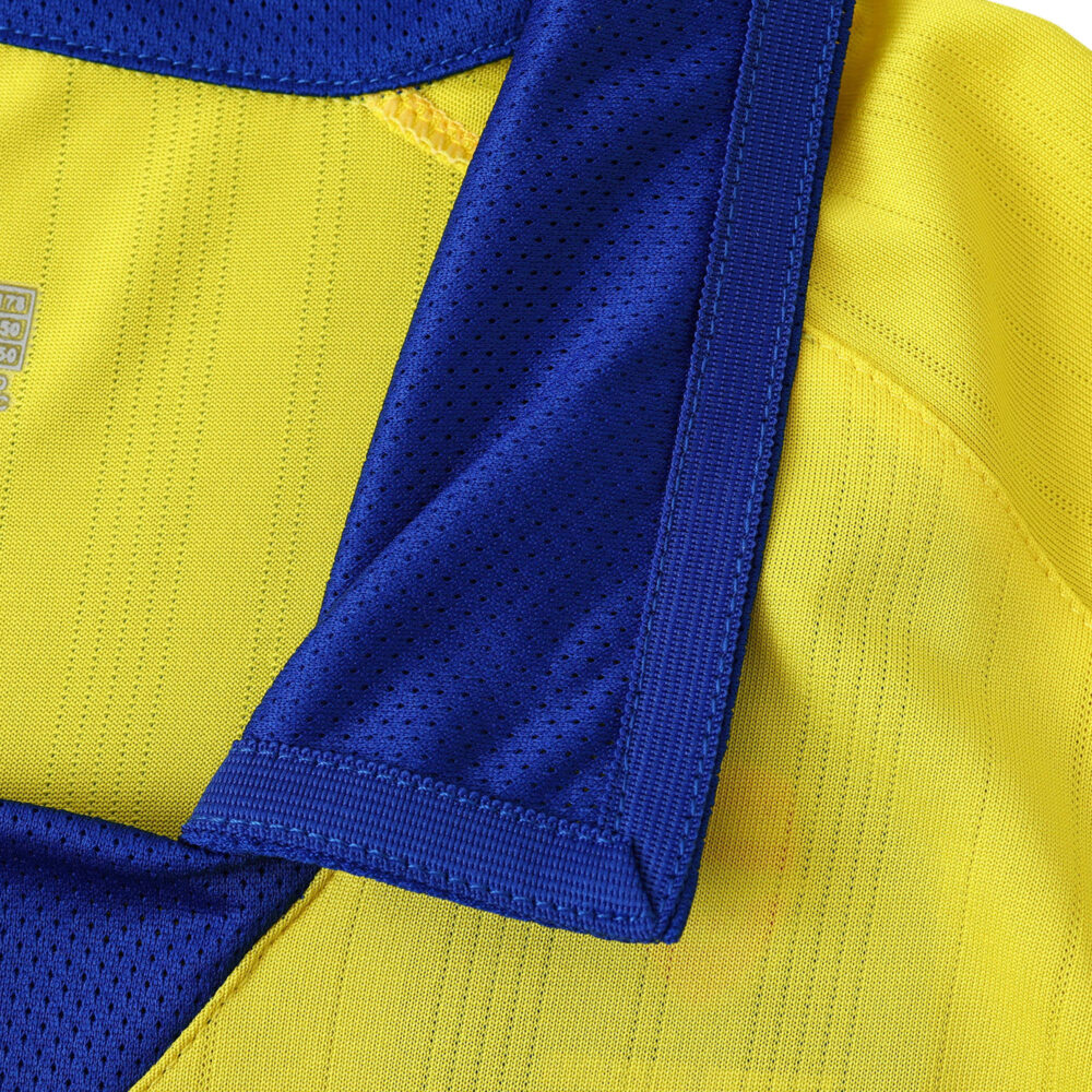 Close-up of the Arsenal Retro Away Fan Version 2003/04 jersey in yellow with blue collar details.