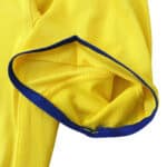 Close-up of the sleeve of Arsenal Retro Away 2003/04 Fan Version jersey in yellow with a blue trim.