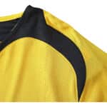 Close-up of Arsenal Retro Away 2005/06 Fan Version jersey, featuring yellow fabric with black curved detailing on the shoulder.