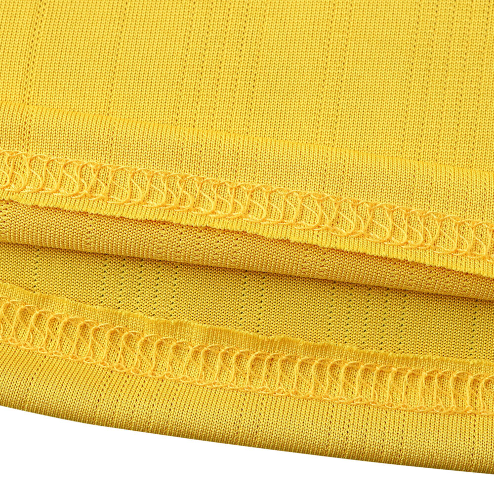 Close-up of the hem detailing and fabric texture of the Arsenal Retro Away 2005/06 fan version jersey in yellow.
