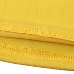 Close-up of the hem detailing and fabric texture of the Arsenal Retro Away 2005/06 fan version jersey in yellow.