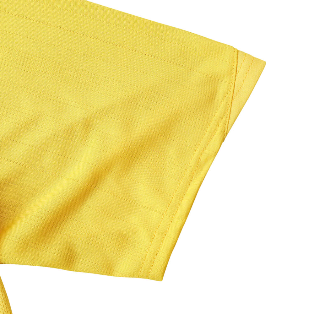 Close-up of the sleeve on the Arsenal Retro Away 2005/06 Fan Version jersey, showing its yellow fabric and stitching.