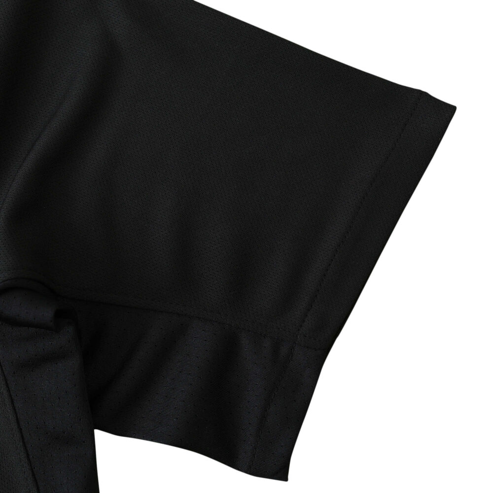 Close-up of the Barcelona Retro Away 2011/12 fan version sleeve, showcasing the black fabric and stitching details.