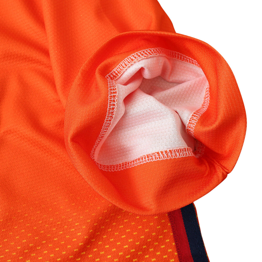 Close-up of sleeve detail on Barcelona Retro Away 2012/13 Fan Version jersey, showing orange fabric and stitching.