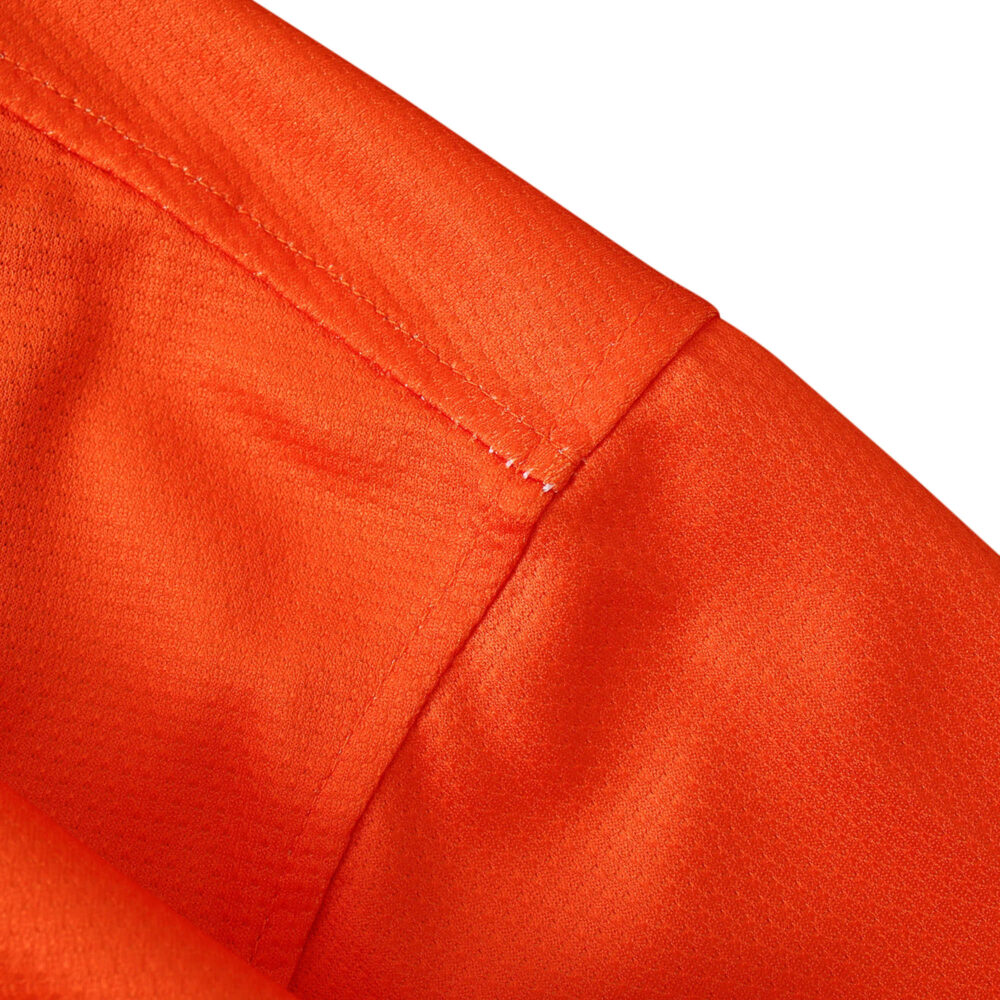 Close-up of the vibrant orange fabric and stitching detail on Barcelona Retro Away Fan Version Jersey from 2012/13 season.