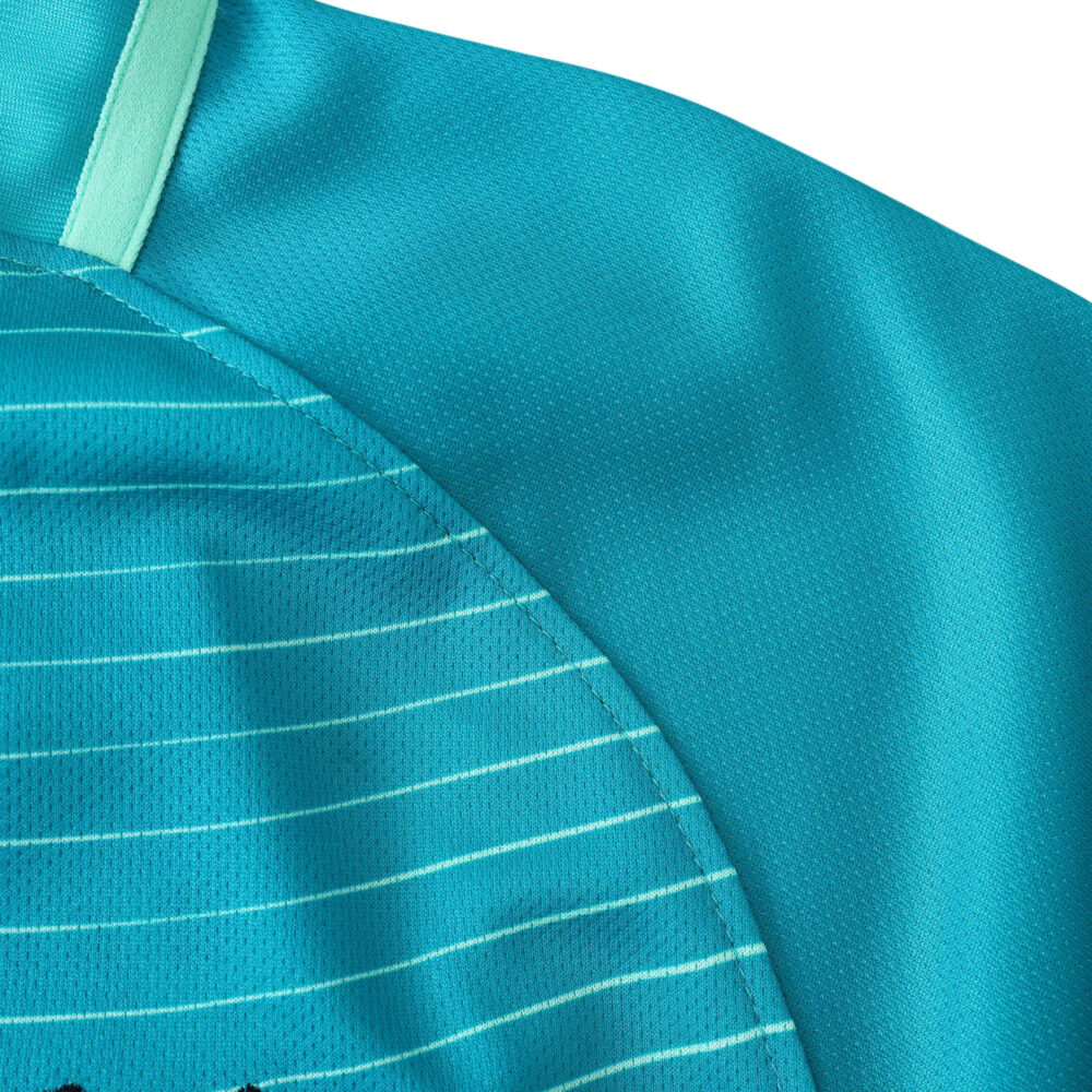 Close-up of the Barcelona Retro Third 2016/17 jersey, highlighting its teal color and fine horizontal stripe details.