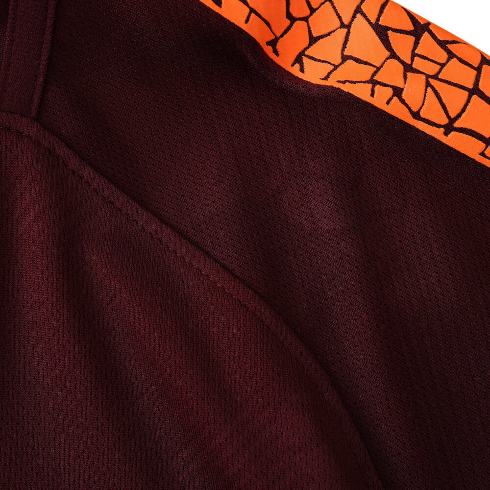 Close-up view of Barcelona Retro Third 2017/18 Fan Version, featuring dark maroon fabric with an orange patterned stripe.
