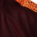 Close-up view of Barcelona Retro Third 2017/18 Fan Version, featuring dark maroon fabric with an orange patterned stripe.