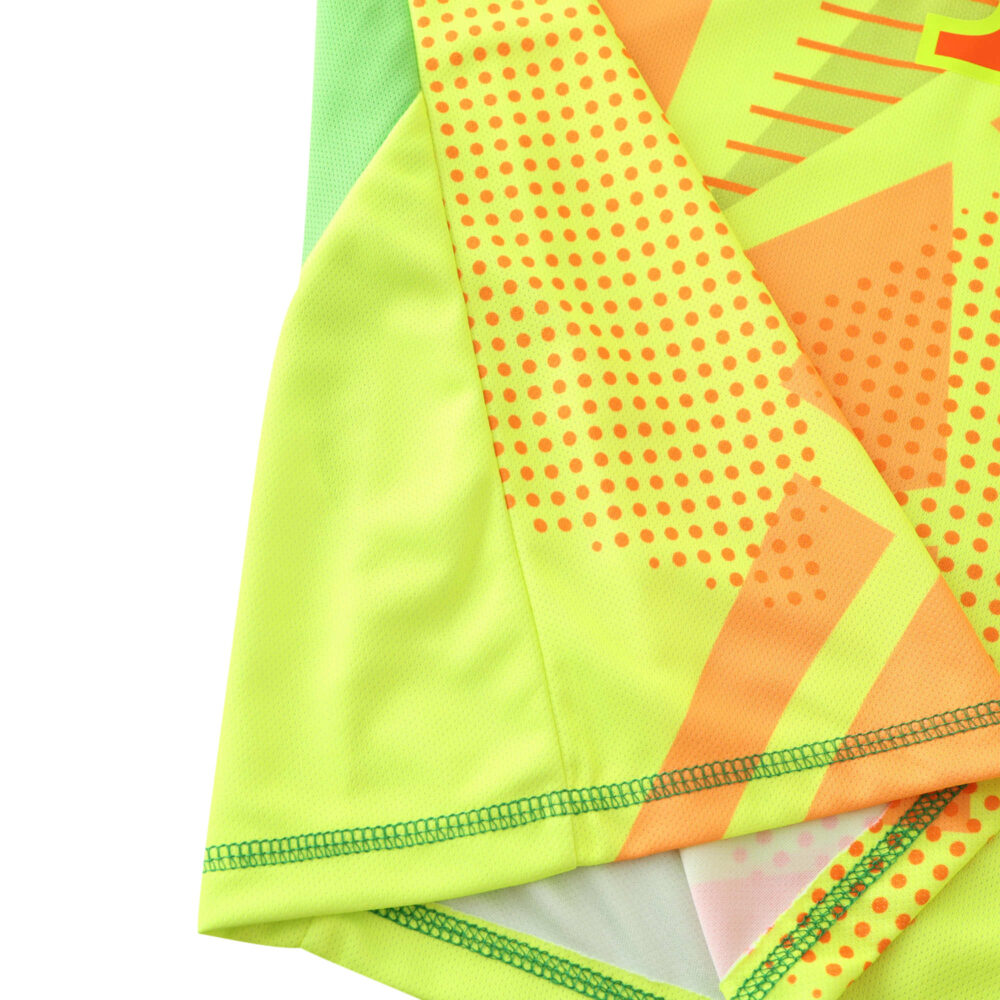 Close-up of Bayern Munich Goalkeeper 2024/25 Fan Version jersey showcasing neon green and yellow fabric with orange patterns.