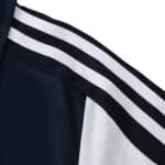 Close-up of the shoulder area of the Chelsea Retro Away 2011/12 Fan Version jersey, featuring black and white stripes.