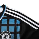 Close-up of Chelsea Retro Third Fan Version jersey from the 2011/12 season, featuring a checkered pattern and club crest.