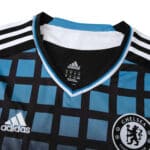Close-up of the Chelsea Retro Third 2011/12 fan version jersey, featuring black and blue checkered pattern with Adidas logo.