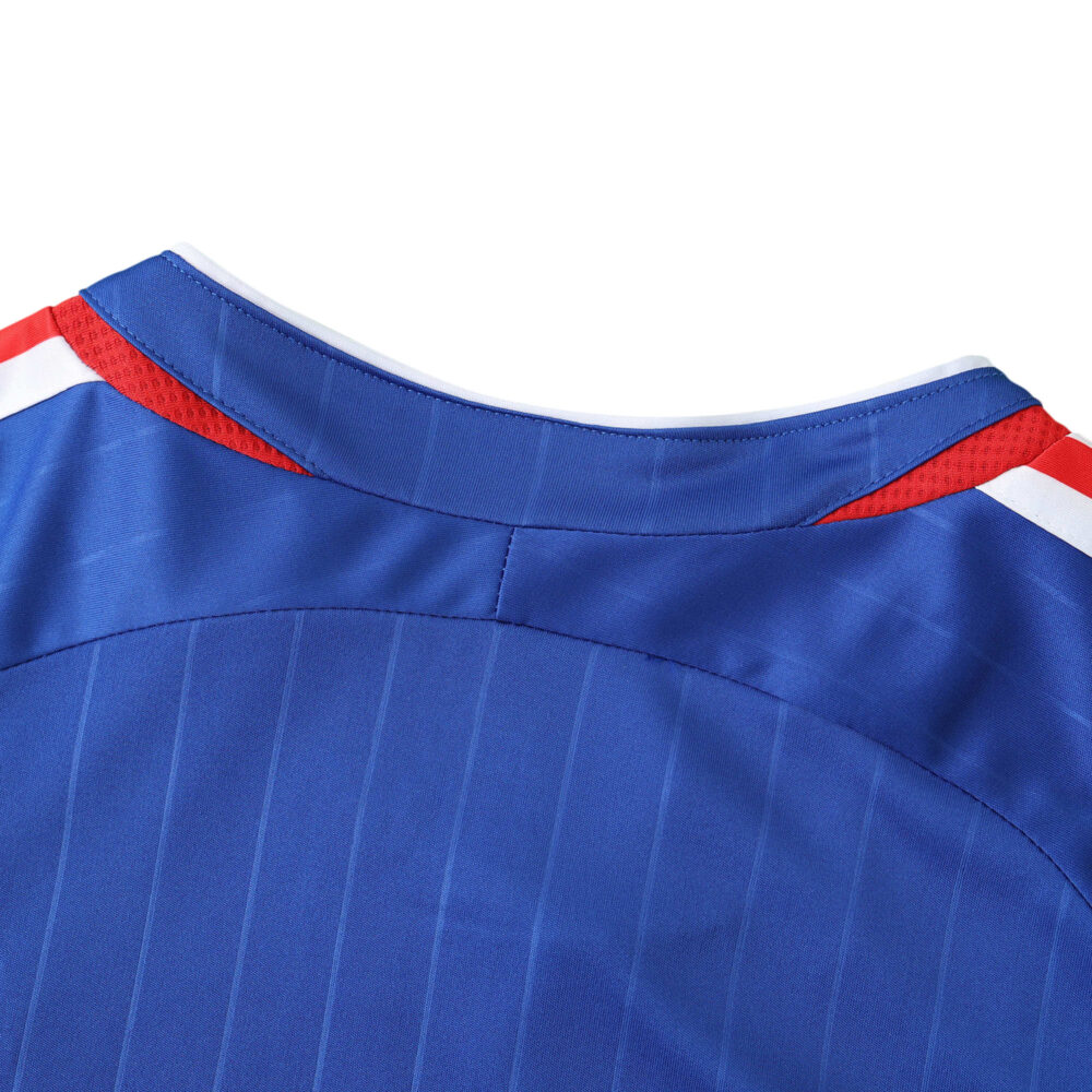 Close-up of the back neckline and collar of the France Retro Home 2006 fan version blue jersey with red and white accents.