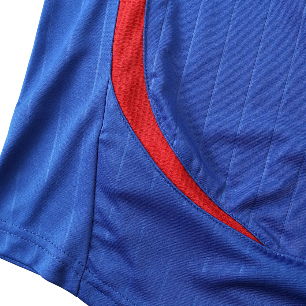 Close-up detail of the France Retro Home 2006 Fan Version jersey with blue fabric and signature red trim.