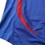 Close-up detail of the France Retro Home 2006 Fan Version jersey with blue fabric and signature red trim.