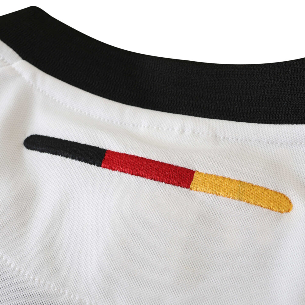 Close-up view of the collar and back neck area of the Germany Retro Home 2002 Fan Version jersey, showing black, red, and yellow stripes.