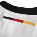 Close-up view of the collar and back neck area of the Germany Retro Home 2002 Fan Version jersey, showing black, red, and yellow stripes.
