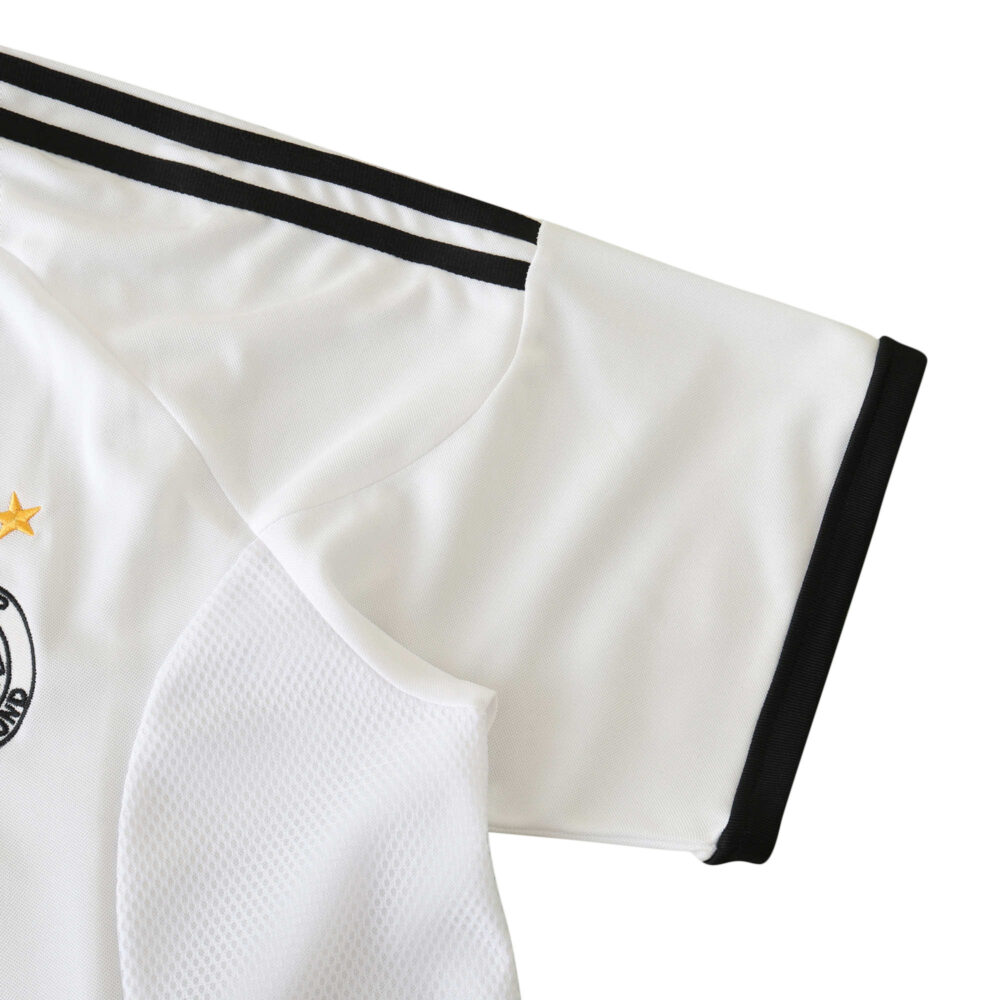 Close-up of the sleeve on the Germany Retro Home 2002 Fan Version jersey, showing black and white stripes and fabric texture.