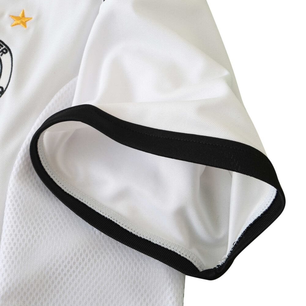 Close-up of the sleeve detail on the Germany Retro Home 2002 Fan Version jersey, featuring black trim and white fabric.