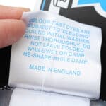 Close-up of care label on Inter Milan Retro Home 1992/93 Fan Version jersey, detailing washing instructions and "Made in England."