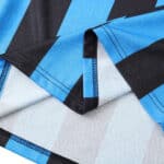 Close-up of Inter Milan Retro Home jersey from the 1992/93 season, showcasing black and blue stripes with detailed stitching.