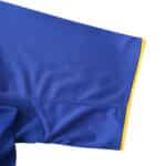 Close-up of the sleeve from the Juventus Retro Away 2004/05 Fan Version jersey, showcasing blue fabric with yellow trimming.
