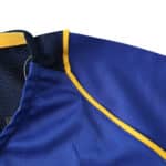 Close-up of the collar and shoulder area of the Juventus Retro Away 2004/05 Fan Version jersey, featuring blue fabric with yellow trim.