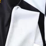 Close-up of Juventus 2004/05 Retro Home Fan Version jersey showcasing the breathable mesh fabric detail in black and white.