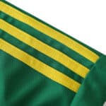 Close-up of the Leeds United Goalkeeper fan version jersey for the 2024/25 season, featuring green fabric and yellow stripes.