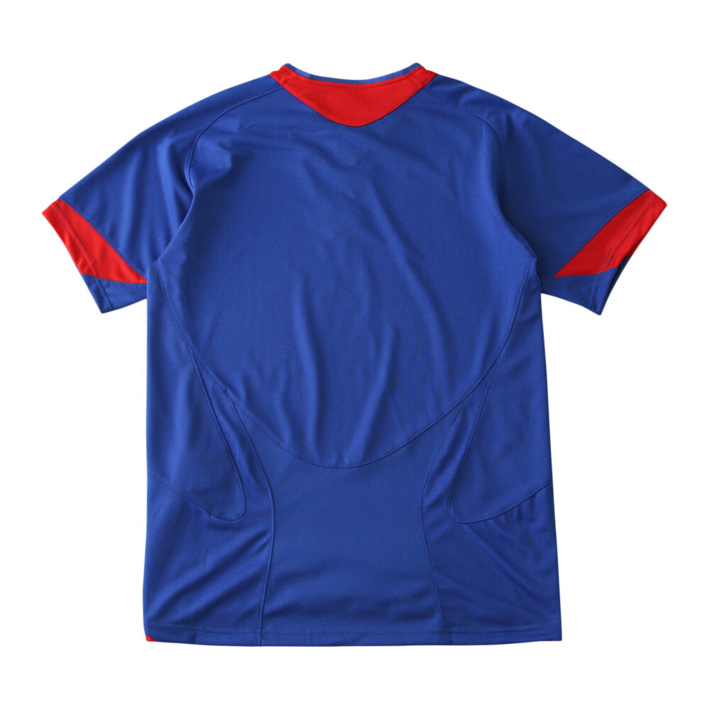 Back view of the Manchester United Retro Away 2005/06 Fan Version jersey, featuring blue with red accents at collar and sleeves.