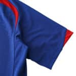 Close-up of the sleeve detail on Manchester United Retro Away | 2005/06 Fan Version, featuring blue fabric with red accents.
