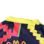 Close-up of the Mexico Retro Goalkeeper 1995 Player Version jersey, featuring a vibrant zigzag pattern in yellow, red, and green.