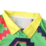 Close-up of the Mexico Retro Goalkeeper 1995 Player Version jersey collar, showcasing vibrant colors and geometric patterns.