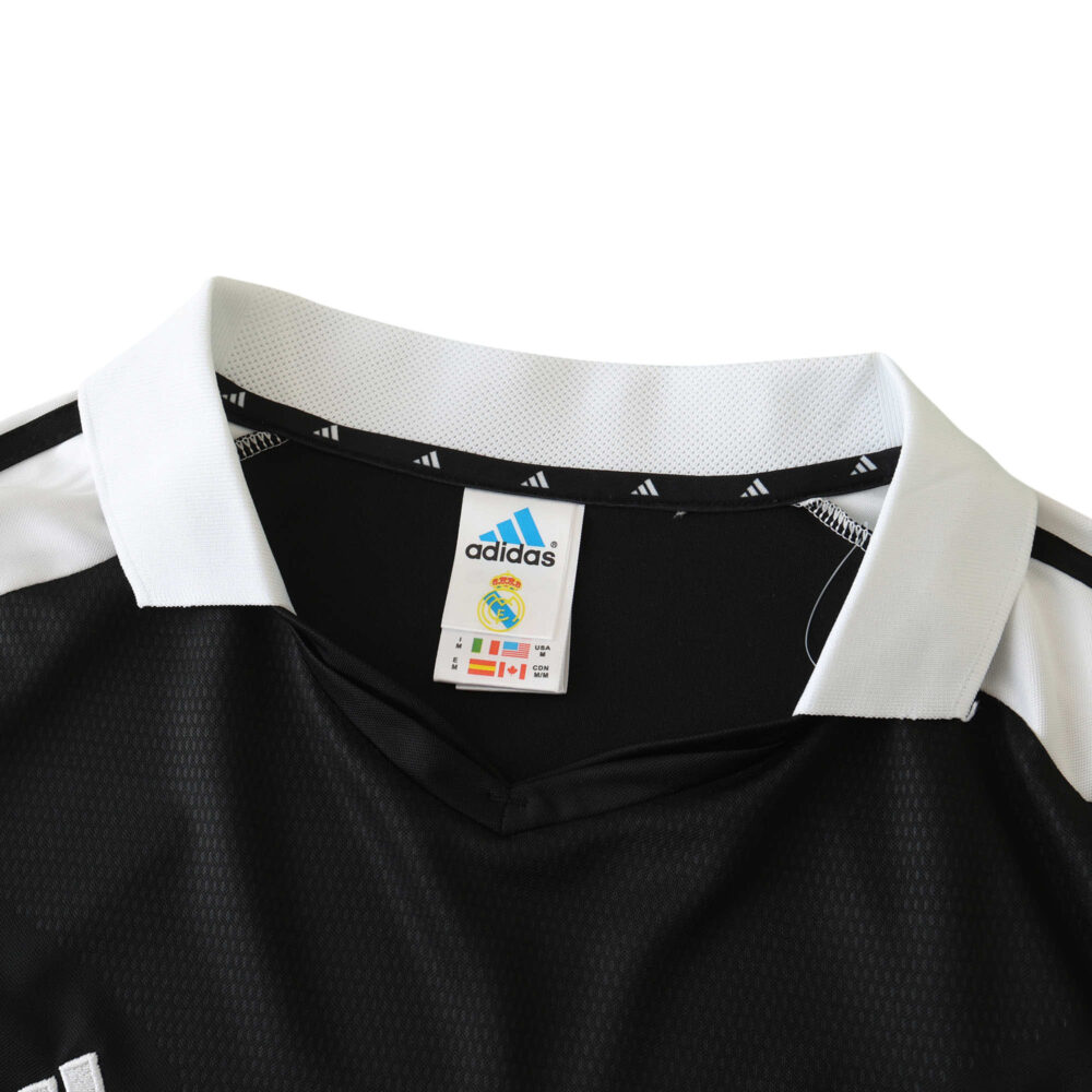 Real Madrid Retro Away jersey, 2001/02 fan version. Black with white collar from Adidas displayed on a product page.