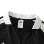 Real Madrid Retro Away jersey, 2001/02 fan version. Black with white collar from Adidas displayed on a product page.