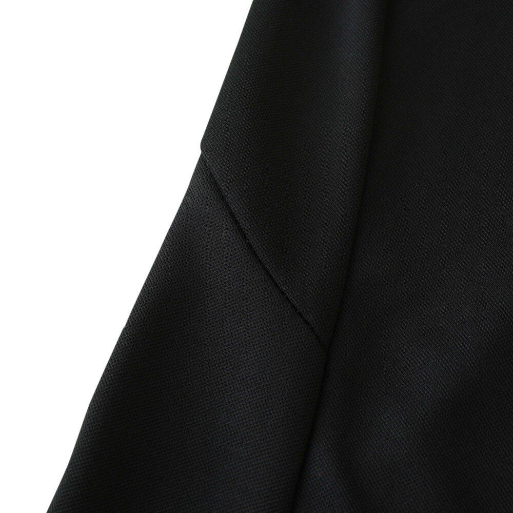 Close-up of the Real Madrid Retro Away fan jersey from 2001/02, showcasing black fabric and stitching details.