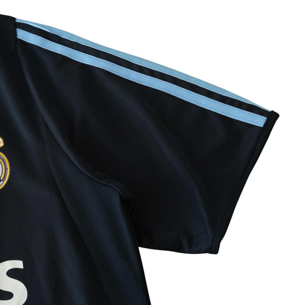 Close-up of the sleeve on a Real Madrid Retro Away jersey, 2003/04 Fan Version with light blue stripes.