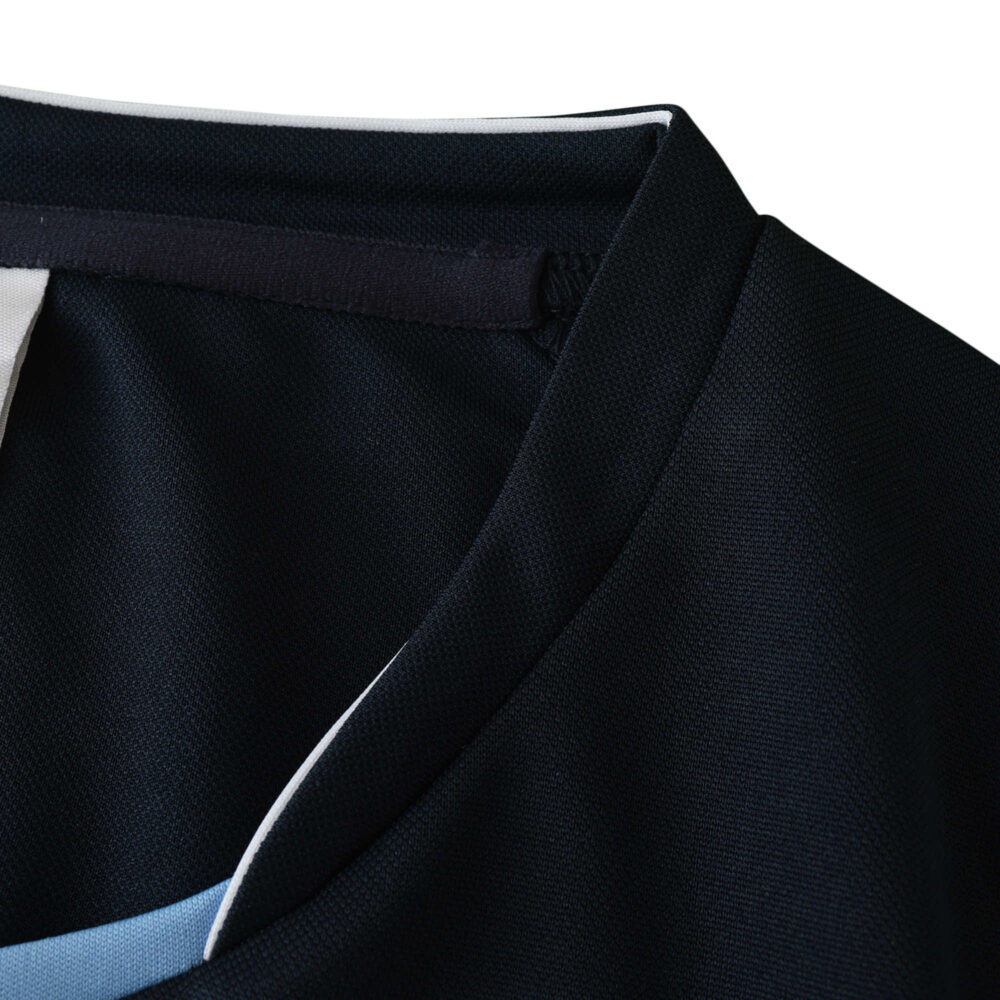 Close-up of the collar and shoulder area of a Real Madrid Retro Away 2003/04 fan version jersey, showing black fabric details.