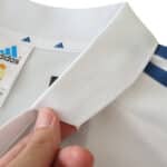 Close-up of the collar and Adidas tag on the Real Madrid Retro Home 2001/02 Fan Version jersey, highlighting fabric detail.