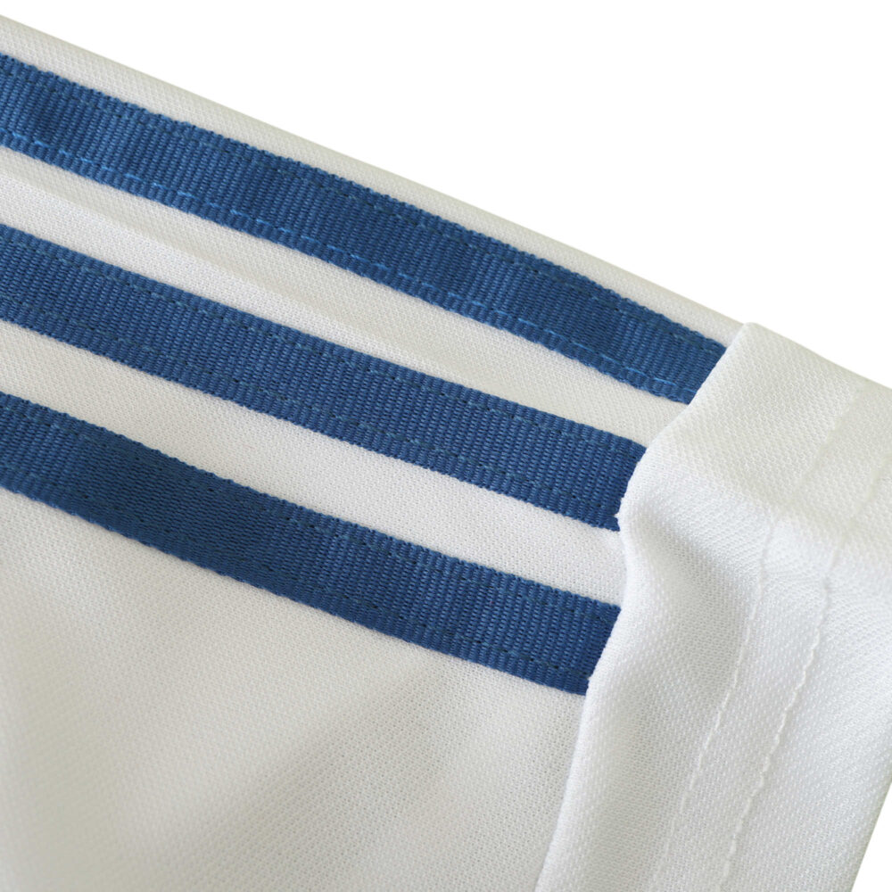 Close-up of the sleeve detail on the Real Madrid Retro Home 2001/02 Fan Version jersey, featuring blue stripes on white fabric.