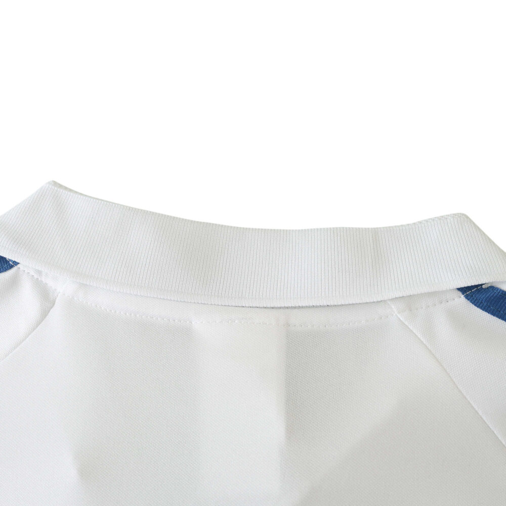 Close-up of the collar and shoulder detail of the Real Madrid Retro Home 2001/02 Fan Version jersey in white with blue accents.